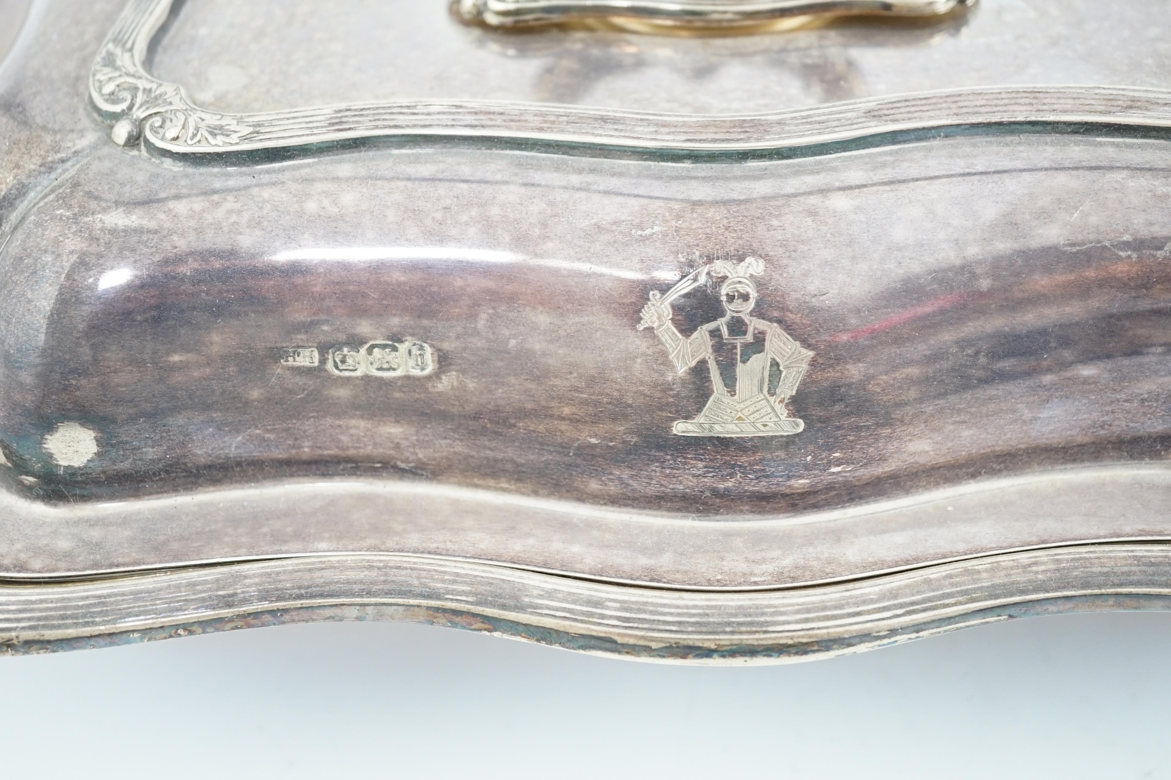 A pair of late Victorian silver entreé dishes and covers, with handles, by Harrison Brothers